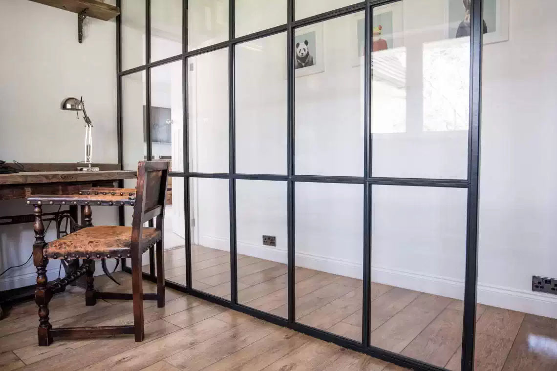 Steel Fixed screen in a modern interior with hardwood floors