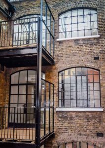 Black steel double door and curved windows