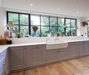 Interior photo of a modern sophisticated kitchen with black Crittall steel windows 